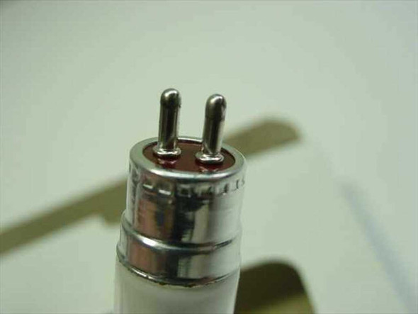 Close-up of Sam Yuk FUL6D/U/4 fluorescent tube 2-pin base connector showing dual pins and metal collar