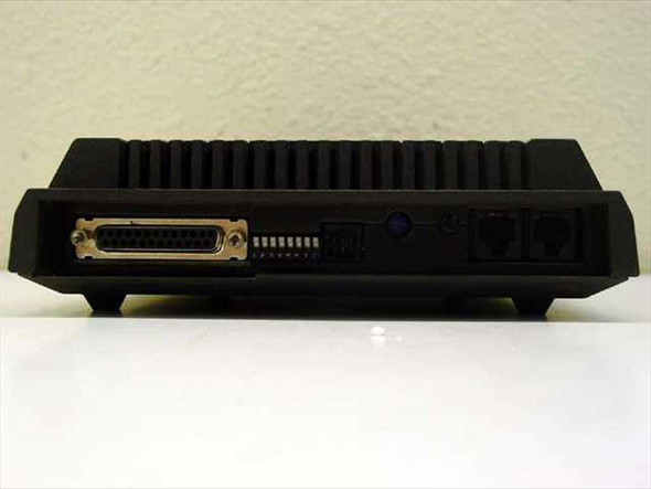 Microcom AX/2400C external modem – rear panel showing DB-25 RS-232 serial port, DIP switches, and RJ-11 phone line connectors