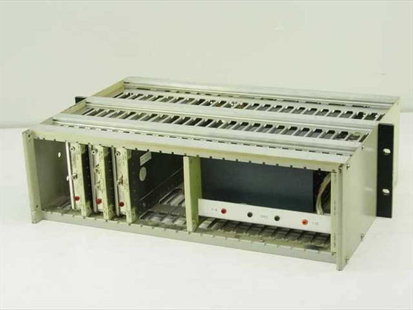 Quintron rackmount modulator chassis three-quarter view from front-right showing empty card slots, installed modulator cards on left side, and power supply module with indicator lights at right