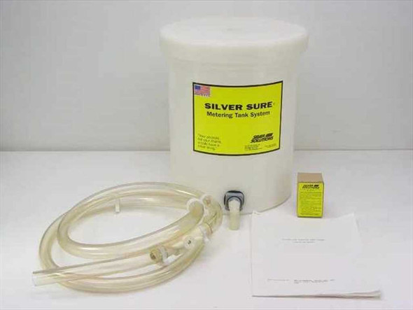 Silver Solutions Silver Sure Metering Tank System – full kit view showing white polyethylene tank with lid, clear tubing, hose clamps, ball valve, small yellow cartridge box, and instruction sheet on white background
