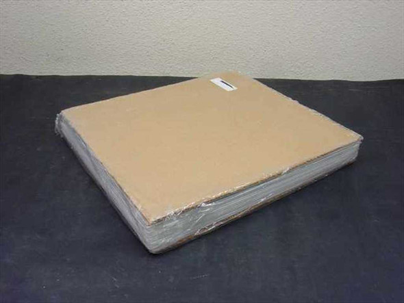 Soda lime glass plates — large wrapped stack of thin 14x14 plates bundled between cardboard sheets, side top view