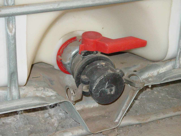 Trustor Coatings 6900 IBC tote – close-up of red lever ball valve outlet fitting at base of tote