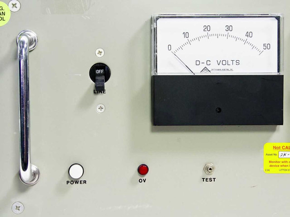 PS242A front panel close-up showing LINE switch, POWER button, OV indicator, TEST button, and DC Volts meter (0–50V scale)