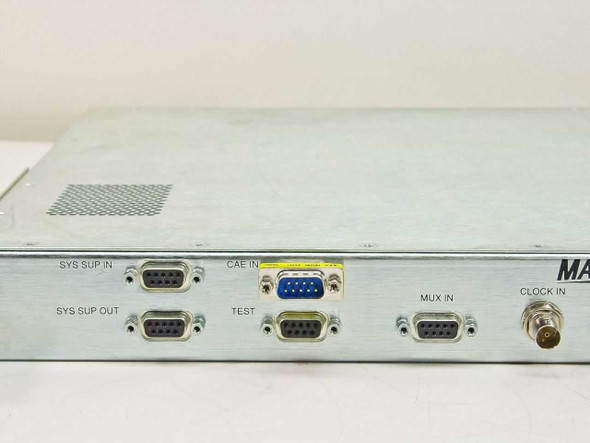 General Instrument Magnitude DVB Scrambling Unit – left side panel detail showing SYS SUP IN, SYS SUP OUT, CAE IN, TEST, and MUX IN DB-9 connectors and CLOCK IN BNC