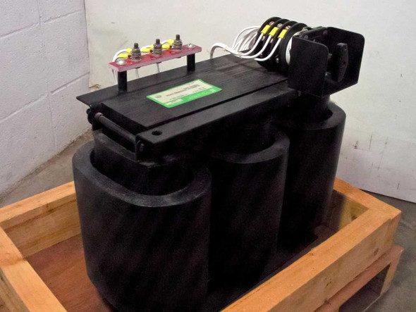 Quality Transformer Electronics 4690 12KVA three-phase klystron transformer — 3/4 front view showing three-core construction, red terminal block on top, and rotary tap selector on right side, unit seated in wooden crate