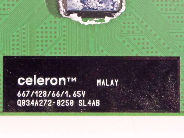 Intel Celeron SL4AB close-up of specification label showing 667/128/66/1.65V and lot code Q034A272-0250