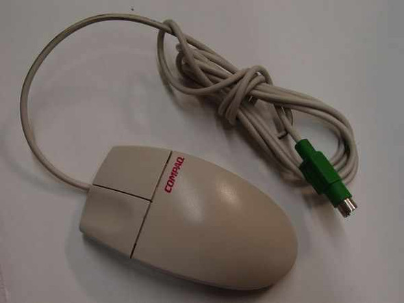 Compaq M-S34 two-button PS/2 mechanical ball mouse, beige body with red Compaq logo, green PS/2 connector, full coiled cable view