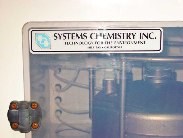 Systems Chemistry Inc. logo and branding label on cabinet door – 'Technology for the Environment, Milpitas, California'