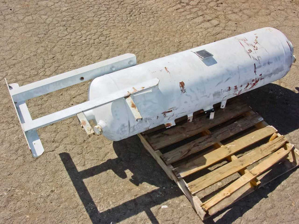 Flair carbon adsorber tank on pallet — opposite side view showing surface rust patches, paint chips, and mounting bracket hardware