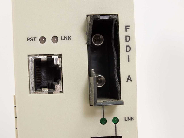Cabletron FDMMIM-24 FDDI A port close-up – cracked and broken MIC fiber connector housing, adjacent RJ-45 port, PST/LNK LEDs