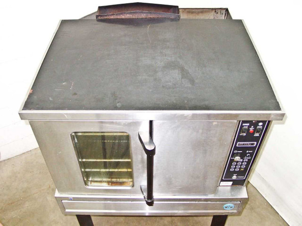 Top surface of US Range CG-100 convection oven showing heavy grease and carbon buildup with black discoloration across the entire top panel