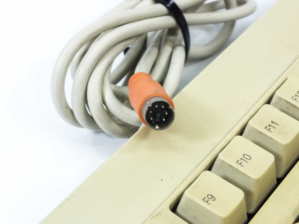 Close-up of Compaq keyboard PS/2 connector — orange 5-pin DIN AT-style plug