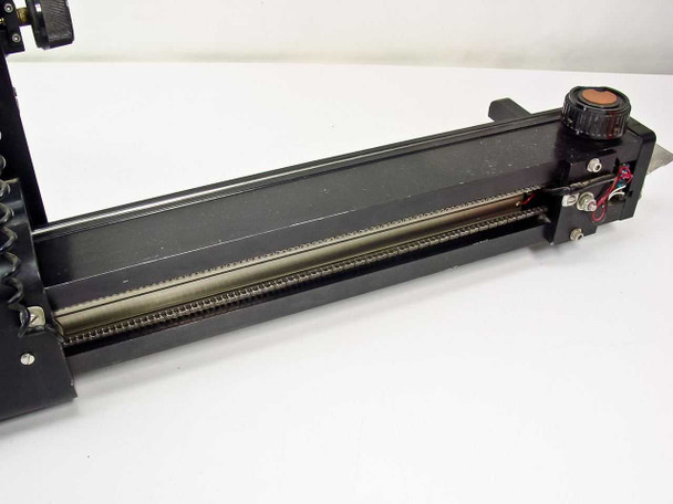 Richards B17266 linear rail detail – right side of base rail showing toothed drive chain, end-mounted knob, and motor/sensor assembly