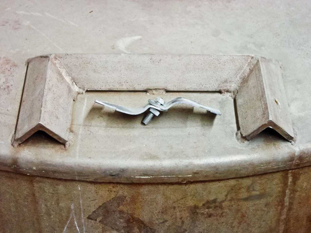 Close-up of drum lid bolt-down clamp hardware on top rim of 350 gallon stainless steel tank