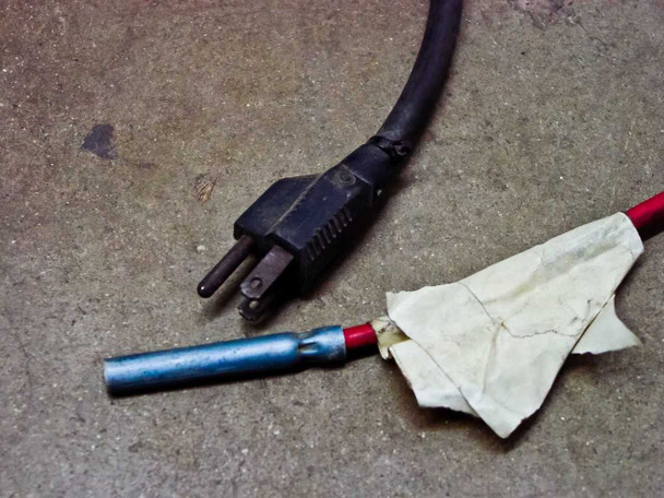 Sun Electric MRC 400 – 120V power cord plug and red service hose end with taped connector, shown on floor