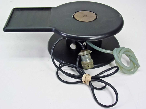 Harris/Farinon 1107 heated wafer chuck — front 3/4 view showing 2.25-inch circular vacuum plate, rectangular tray extension, black body, multi-pin mil-spec connector, and clear pneumatic tubing
