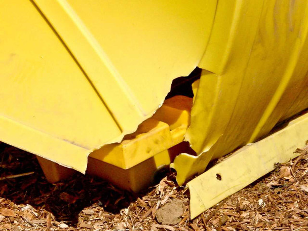 Eagle 1646RTC closeup of damaged lower cover corner — showing cracked and broken yellow polyethylene at base of rotary cover