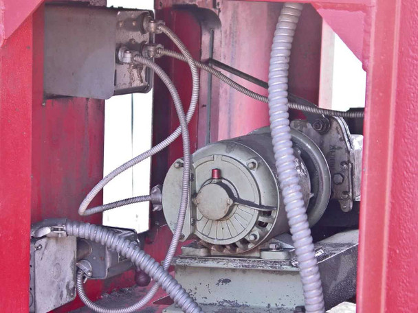 Interior cabinet view showing Gryphon motor mounted inside red-painted enclosure with flexible conduit wiring