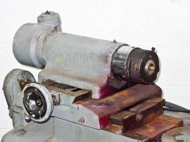 Left-side spindle motor assembly mounted on cross-slide showing motor housing and spindle end
