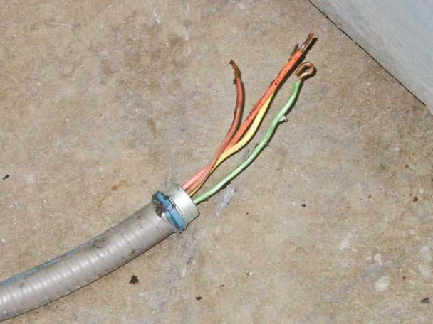 Power cable termination — bare multi-conductor wire ends (brown, red, green/yellow, orange) exiting flexible metal conduit — no plug fitted