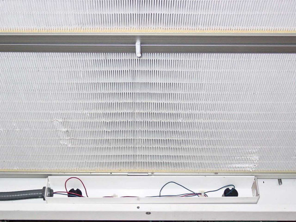 Close-up of HEPA filter area and light fixture trough showing bare red, black, and blue wiring awaiting connection