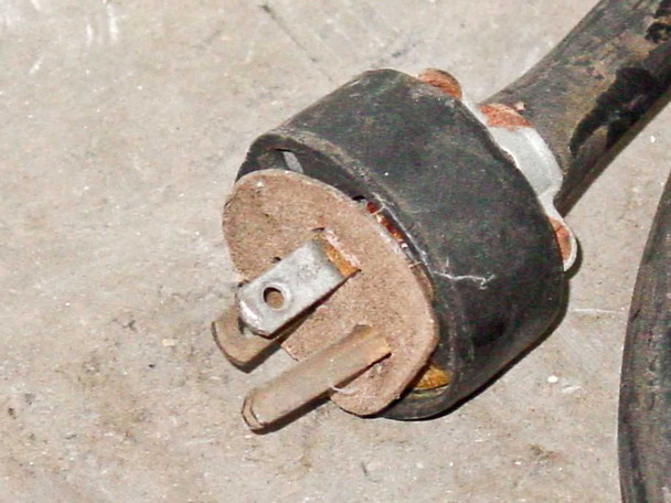 Close-up of aged 3-prong power plug and cord attached to F&B/CECO film splicer showing heavy wear and corrosion