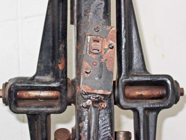 Lower column and base detail of F&B/CECO film splicer showing toggle switch, spring-loaded foot pads, and heavy cast iron base