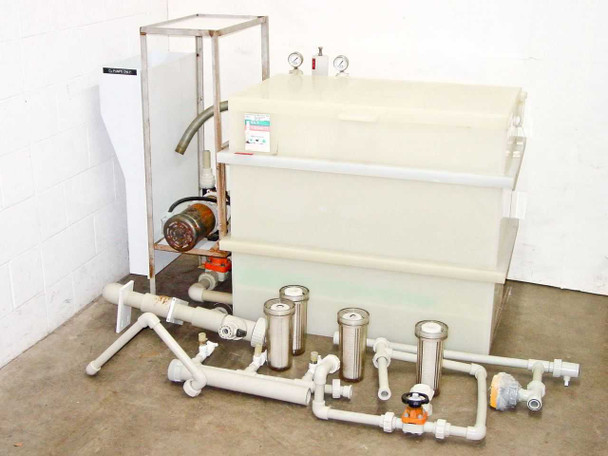 HDPE chemical reservoir tank system with Iwaki magnetic drive pump, three inline liquid filter housings, and PVC piping assembly — full system overview