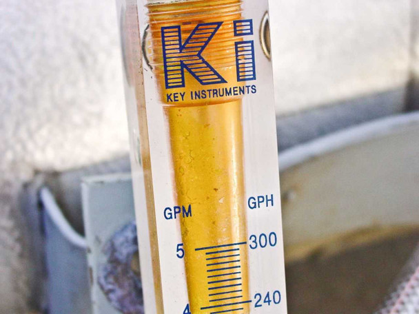 Close-up of Key Instruments rotameter float tube showing scale detail — 4–5 GPM (240–300 GPH) range visible, amber float, KEY INSTRUMENTS branding clearly legible