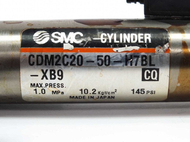 SMC CDM2C20-50-H7BL cylinder label closeup showing model number, XB9 suffix, CQ mark, max pressure 1.0 MPa 145 PSI, Made in Japan