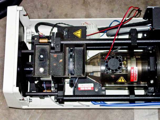 Interior of Spectra-Physics 2020-11 laser head showing plasma tube, high voltage components, steering mirrors, and cooling fan assembly