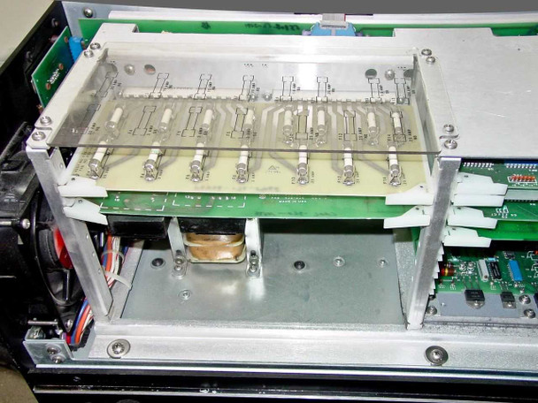 Interior of Spectra-Physics 2560 power supply showing control board assembly with slide potentiometers and green PCBs on upper chassis
