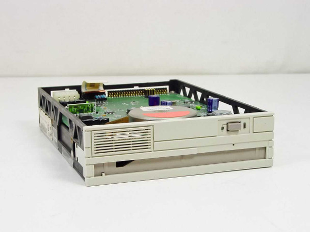 Omega Beta 20B vintage optical drive – front-right 3/4 view showing beige front bezel, eject button, top cover removed revealing PCB and disc mechanism