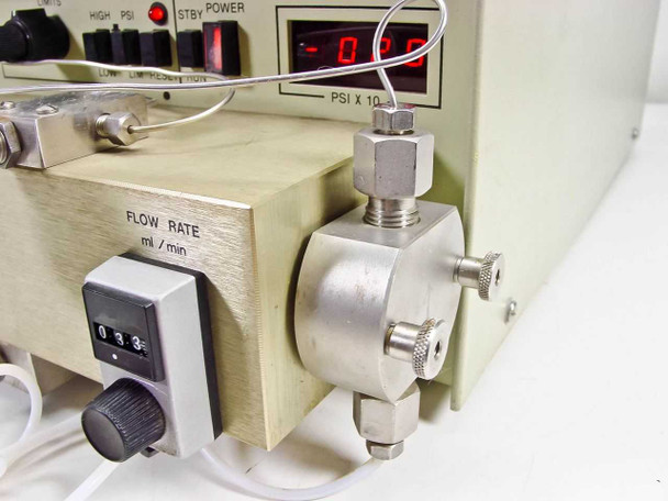 LDC ConstaMetric III G pump right side showing FLOW RATE ml/min mechanical dial set to 0.33 and stainless steel reciprocating pump head with fittings