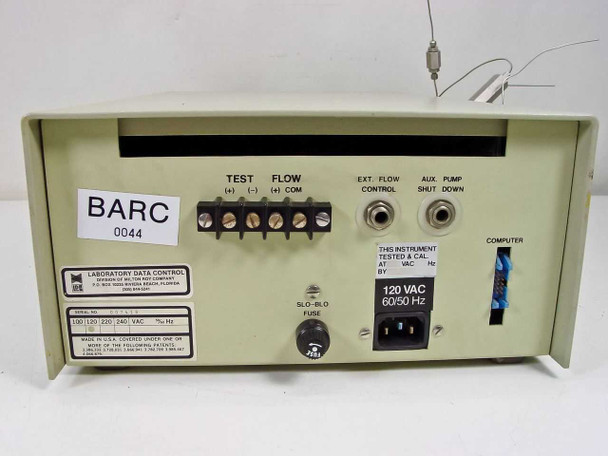 LDC ConstaMetric III G rear panel showing TEST and FLOW terminal block, EXT FLOW CONTROL jack, AUX PUMP SHUT DOWN jack, COMPUTER connector, SLO-BLO fuse, IEC AC inlet rated 120VAC 60/50Hz, and BARC asset tag 0044