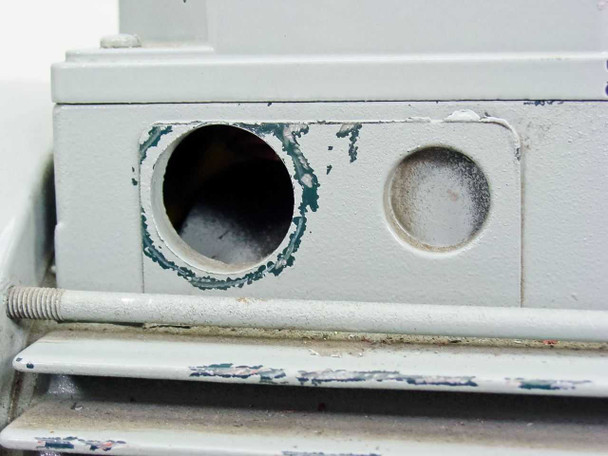 Bell & Gossett FST 3000 pump base — close-up of mounting foot showing significant paint chipping and surface corrosion around port openings