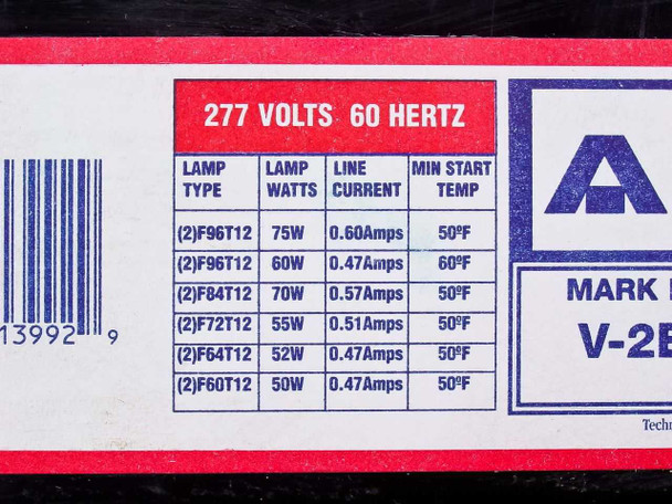 Close-up of lamp compatibility chart label: 277V 60Hz, compatible lamp types F96T12 through F60T12 with wattage and line current data
