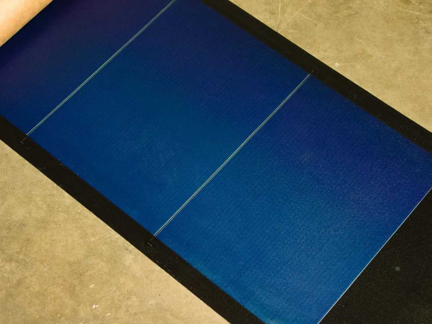 Close-up of Uni-Solar PVL-136 amorphous solar cell surface showing three blue triple-junction cell sections with interconnect lines