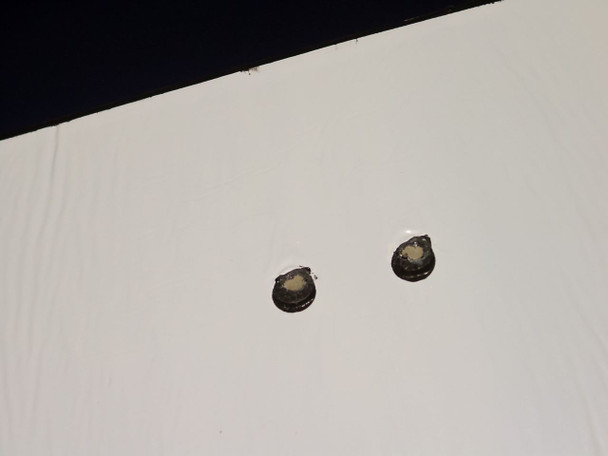 Reverse side of Uni-Solar PVL-136 flexible panel showing two solder point connections on white backing material
