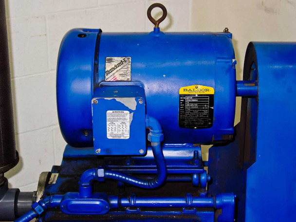 Baldor industrial motor mounted on top of Tuthill KTC112 vacuum pump — right side view