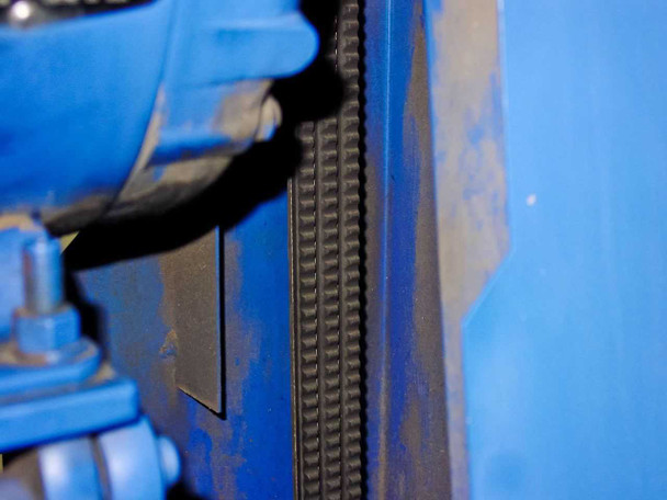 Drive belt close-up on Tuthill KTC112 vacuum pump — V-belt visible between motor and pump sheaves