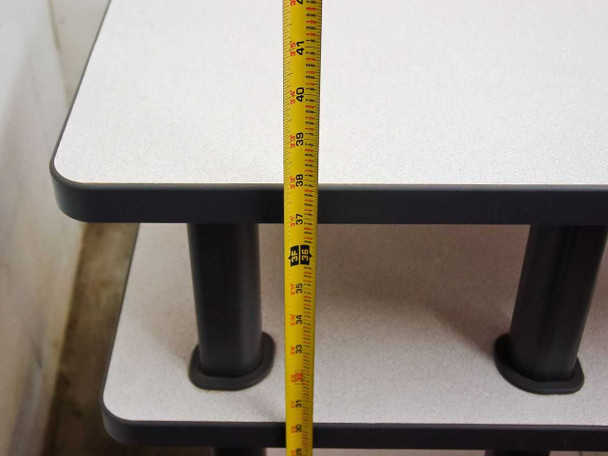 Tape measure showing desk height at approximately 38-41 inches from lower shelf to upper tier