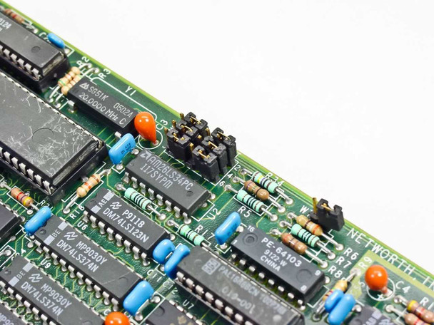 Networth EtherNext PCB 1012-1 close-up macro of logic ICs including AM29LS33PC, DM74LS123N, MP3030Y, and PE-64103 components with jumper headers