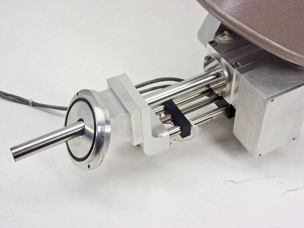 Close-up of PGT PRISM60 motorized linear positioning stage with stainless steel rails, lead screw, and detector mount assembly