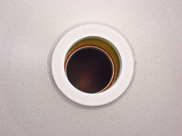 Top-down view of PGT PRISM60 detector snout aperture showing circular opening with amber/brown window — detector entry port