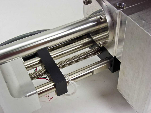 Close-up of PGT PRISM60 motorized stage stainless steel rails, lead screw, and wiring harness with red paper tag visible
