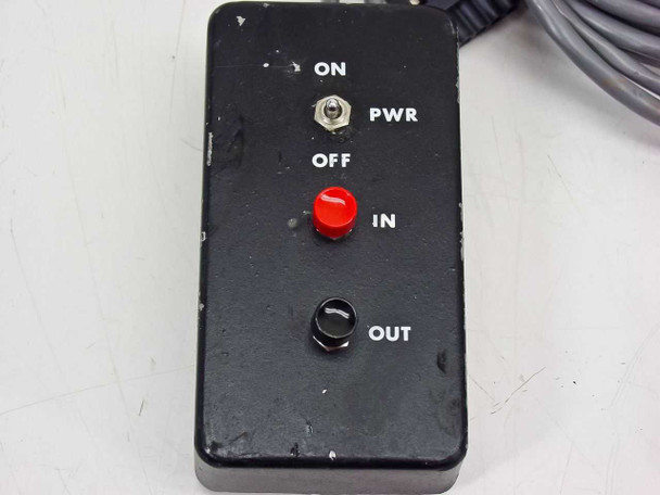 Close-up of PGT PRISM60 control box front panel showing ON/OFF PWR toggle, red IN indicator/button, and OUT toggle switch
