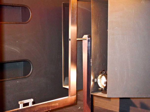 Interior left side wall of CRP L-207-B chamber showing oval cutouts and plate holder vertical rail assembly with incandescent socket