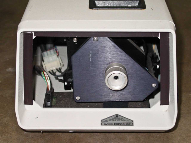 Interior view of Spectra-Physics 2020-05 dye laser with top cover removed, showing optical cavity assembly, angled dye cell mount, circular output coupler, and internal wiring harness