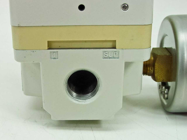 SMC IR2020-02BG close-up of SUP (supply) inlet port showing threaded opening and port label